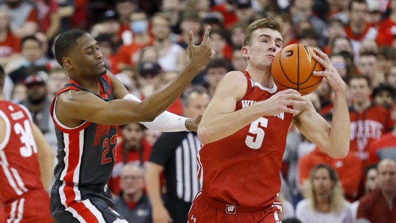 Dec 11, 2021; Columbus, Ohio, USA; Wisconsin Badgers forward Tyler Wahl (5) steals from Ohio State Buckeyes guard Malaki Branham (22) during the first half at Value City Arena. Mandatory Credit: Joseph Maiorana-USA TODAY Sports