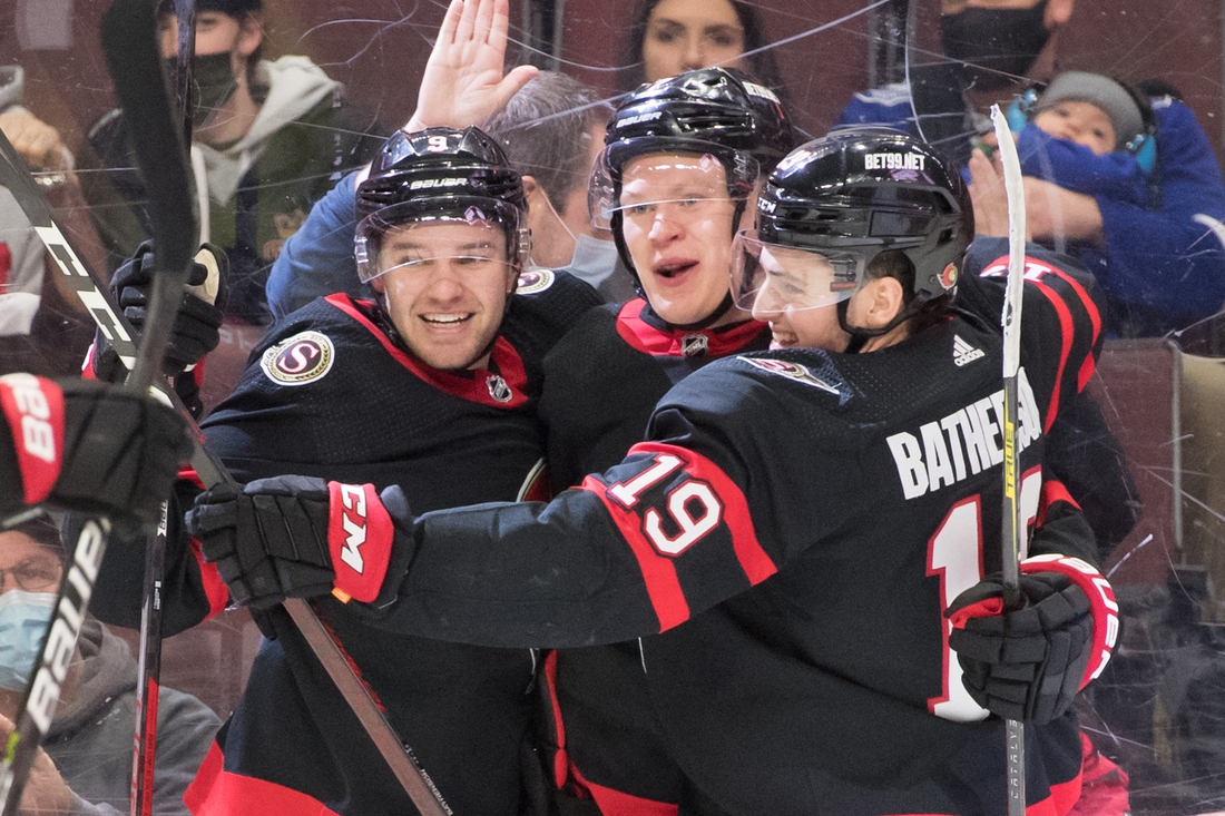 Dec 11, 2021; Ottawa, Ontario, CAN; Ottawa Senators left wing Brady Tkachuk (7-center) celebrates with center Josh Norris (9-left) and right wing Drake Batherson (19-right) his goal scored in the second period against the Tampa Bay Lightning at the Canadian Tire Centre. Mandatory Credit: Marc DesRosiers-USA TODAY Sports