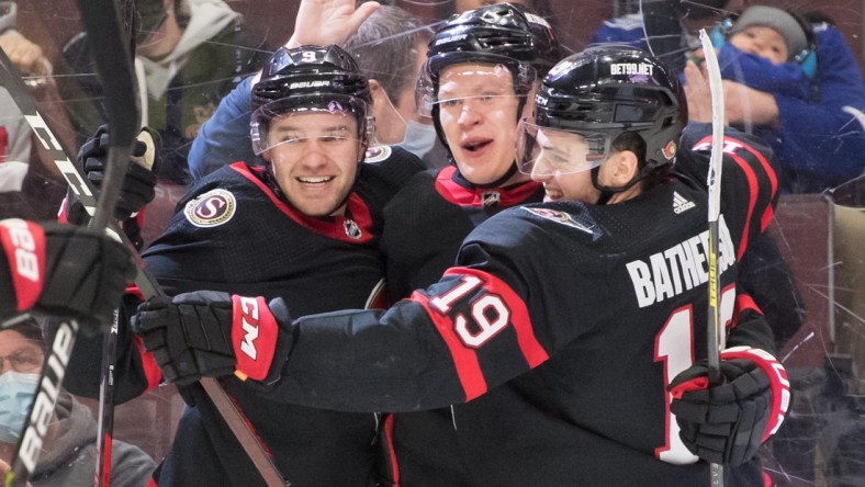 Dec 11, 2021; Ottawa, Ontario, CAN; Ottawa Senators left wing Brady Tkachuk (7-center) celebrates with center Josh Norris (9-left) and right wing Drake Batherson (19-right) his goal scored in the second period against the Tampa Bay Lightning at the Canadian Tire Centre. Mandatory Credit: Marc DesRosiers-USA TODAY Sports