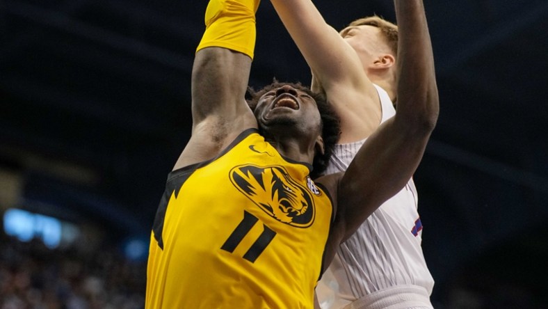 fDec 11, 2021; Lawrence, Kansas, USA; Missouri Tigers forward Yaya Keita (11) has his shot blocked by Kansas Jayhawks guard Christian Braun (2) during the first half at Allen Fieldhouse. Mandatory Credit: Jay Biggerstaff-USA TODAY Sports