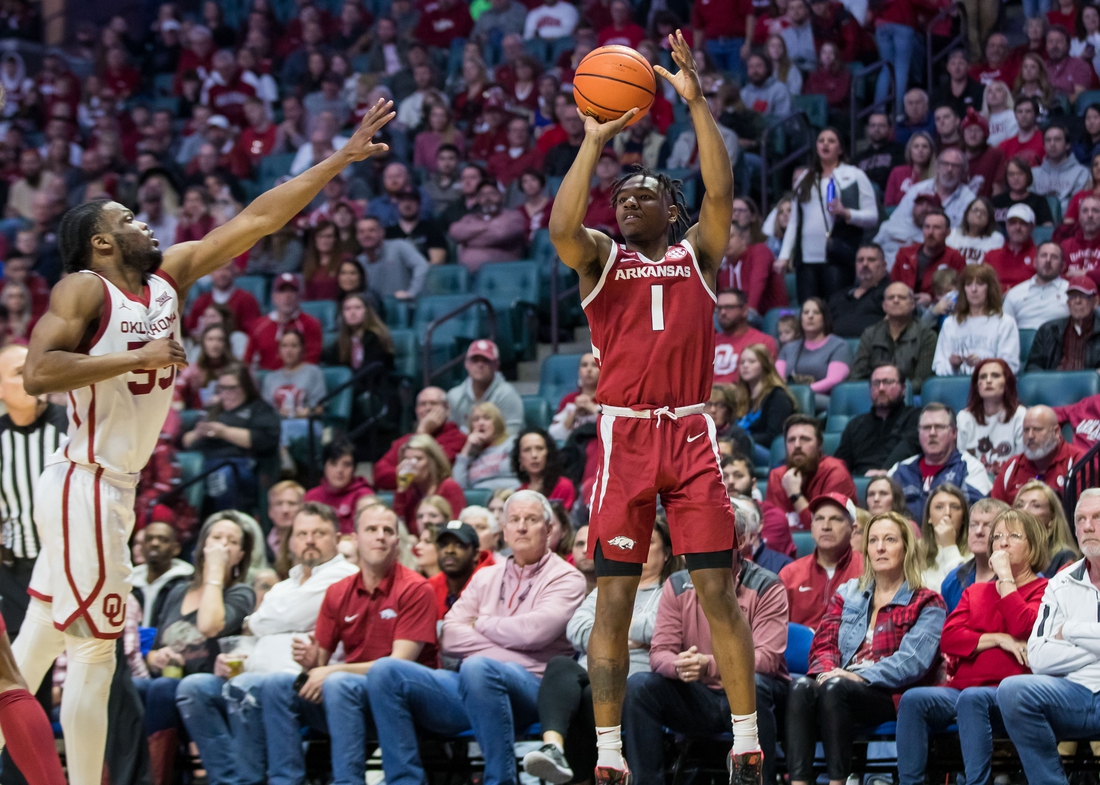 Dec 11, 2021; Tulsa, Oklahoma, USA;  Arkansas Razorbacks guard JD Notae (1) shoots the ball as Oklahoma Sooners guard Elijah Harkless (55) tries to block it during the second half at BOK Center. Oklahoma won 88-66. Mandatory Credit: Brett Rojo-USA TODAY Sports