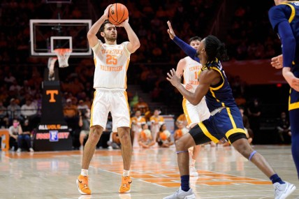 Tennessee guard Santiago Vescovi (25) shoots the ball over UNC Greensboro forward Miles Jones (13) during a game at Thompson-Boling Arena in Knoxville, Tenn. on Saturday, Dec. 11, 2021. 

Kns Tennessee Greensboro Basketball
