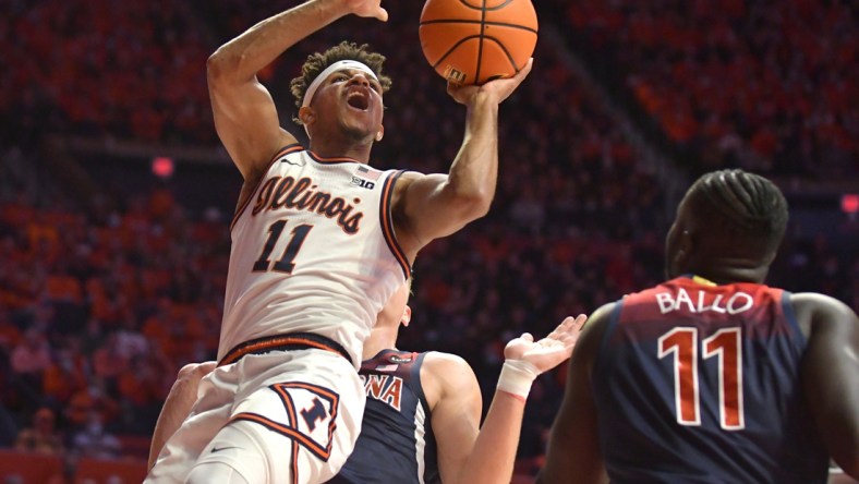 Dec 11, 2021; Champaign, Illinois, USA; Illinois Fighting Illini guard Alfonso Plummer (11) shoots the ball over Arizona Wildcats center Oumar Ballo (11) during the first half at State Farm Center. Mandatory Credit: Ron Johnson-USA TODAY Sports