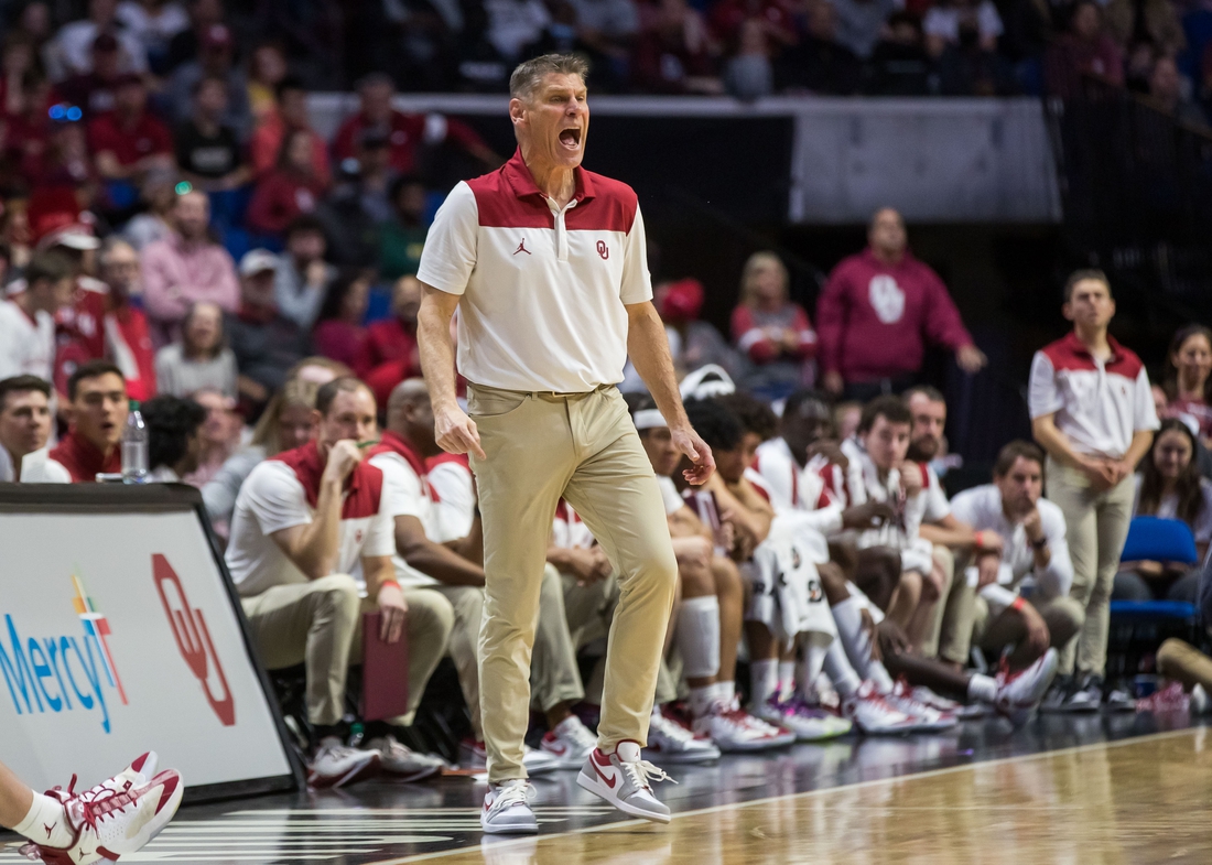 Dec 11, 2021; Tulsa, Oklahoma, USA;  Oklahoma Sooners head coach Porter Moser yells towards his players on the floor during the first half against the Arkansas Razorbacks at BOK Center. Oklahoma won 88-66. Mandatory Credit: Brett Rojo-USA TODAY Sports