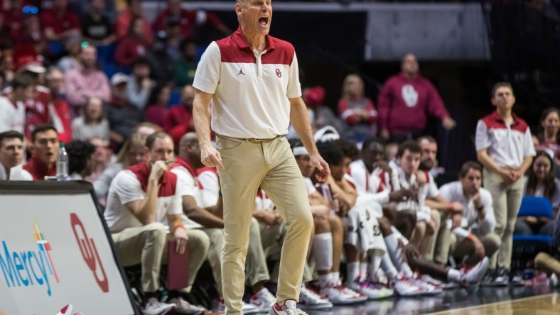 Dec 11, 2021; Tulsa, Oklahoma, USA;  Oklahoma Sooners head coach Porter Moser yells towards his players on the floor during the first half against the Arkansas Razorbacks at BOK Center. Oklahoma won 88-66. Mandatory Credit: Brett Rojo-USA TODAY Sports