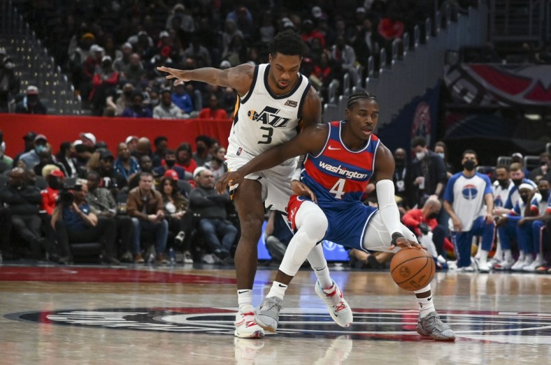 Dec 11, 2021; Washington, District of Columbia, USA;  Washington Wizards guard Aaron Holiday (4) dribbles as Utah Jazz guard Trent Forrest (3) defends during the first half at Capital One Arena. Mandatory Credit: Tommy Gilligan-USA TODAY Sports