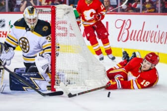 Dec 11, 2021; Calgary, Alberta, CAN; Calgary Flames left wing Matthew Tkachuk (19) reach for the puck in front of Boston Bruins goaltender Linus Ullmark (35) during the first period at Scotiabank Saddledome. Mandatory Credit: Sergei Belski-USA TODAY Sports