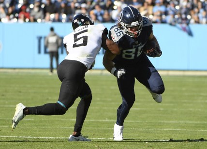 Dec 12, 2021; Nashville, Tennessee, USA;  Tennessee Titans tight end Anthony Firkser (86) runs through the tackle of Jacksonville Jaguars defensive back Rudy Ford (5) during the first half at Nissan Stadium. Mandatory Credit: Steve Roberts-USA TODAY Sports