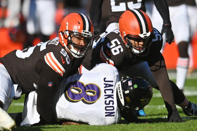Dec 12, 2021; Cleveland, Ohio, USA; Cleveland Browns defensive end Myles Garrett (95) looks up to check the spot after tackling Baltimore Ravens quarterback Lamar Jackson (8) during the first quarter at FirstEnergy Stadium. Mandatory Credit: Ken Blaze-USA TODAY Sports