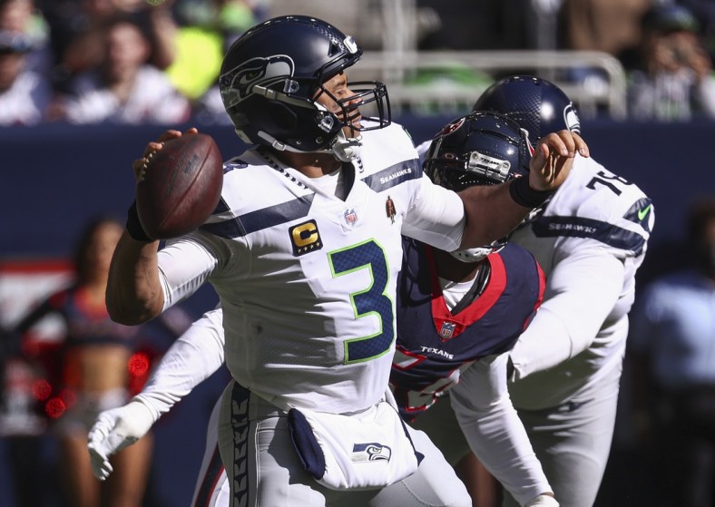 Dec 12, 2021; Houston, Texas, USA; Seattle Seahawks quarterback Russell Wilson (3) attempts a pass during the second quarter against the Houston Texans at NRG Stadium. Mandatory Credit: Troy Taormina-USA TODAY Sports