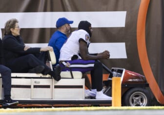 Dec 12, 2021; Cleveland, Ohio, USA; Baltimore Ravens quarterback Lamar Jackson (8) rides the medical cart back to the locker room during the second quarter against the Cleveland Browns at FirstEnergy Stadium. Mandatory Credit: Scott Galvin-USA TODAY Sports