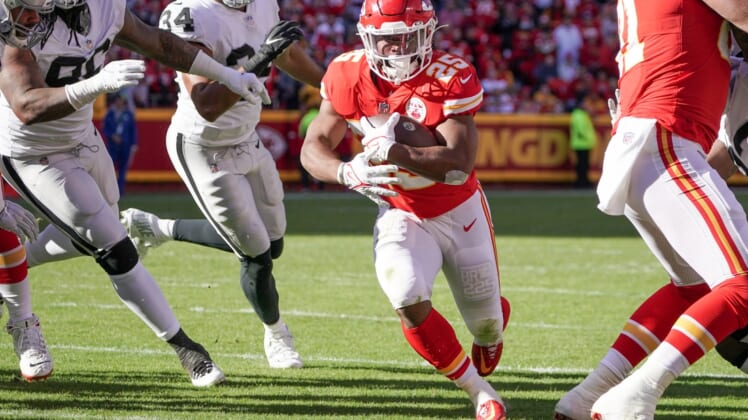 Dec 12, 2021; Kansas City, Missouri, USA; Kansas City Chiefs running back Clyde Edwards-Helaire (25) runs in for a touchdown against the Las Vegas Raiders during the first half at GEHA Field at Arrowhead Stadium. Mandatory Credit: Denny Medley-USA TODAY Sports