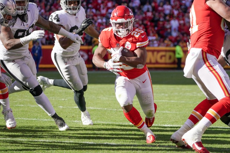 Dec 12, 2021; Kansas City, Missouri, USA; Kansas City Chiefs running back Clyde Edwards-Helaire (25) runs in for a touchdown against the Las Vegas Raiders during the first half at GEHA Field at Arrowhead Stadium. Mandatory Credit: Denny Medley-USA TODAY Sports