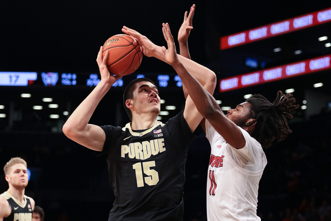 Dec 12, 2021; Brooklyn, New York, USA; Purdue Boilermakers center Zach Edey (15) shoots the ball as North Carolina State Wolfpack forward Jaylon Gibson (11) defends during the first half at Barclays Center. Mandatory Credit: Vincent Carchietta-USA TODAY Sports