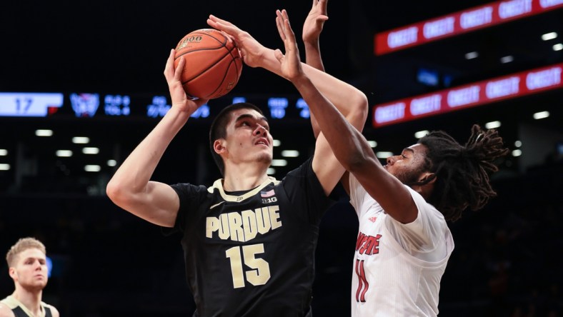 Dec 12, 2021; Brooklyn, New York, USA; Purdue Boilermakers center Zach Edey (15) shoots the ball as North Carolina State Wolfpack forward Jaylon Gibson (11) defends during the first half at Barclays Center. Mandatory Credit: Vincent Carchietta-USA TODAY Sports