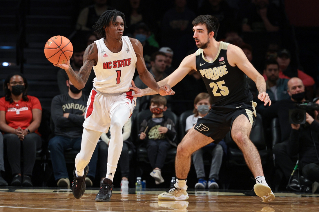 Dec 12, 2021; Brooklyn, New York, USA; North Carolina State Wolfpack guard Dereon Seabron (1) passes the ball as Purdue Boilermakers guard Ethan Morton (25) defends during the first half at Barclays Center. Mandatory Credit: Vincent Carchietta-USA TODAY Sports