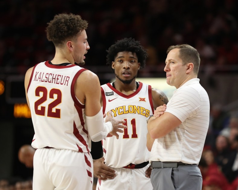 Dec 12, 2021; Ames, Iowa, USA; Iowa State Cyclones head coach T. J. Otzelberger talks with Iowa State Cyclones guard Gabe Kalscheur (22) and Iowa State Cyclones guard Tyrese Hunter (11) during their game with the Jackson State Tigers at James H. Hilton Coliseum. The Cyclones beat the Tigers 47 to 37.  Mandatory Credit: Reese Strickland-USA TODAY Sports