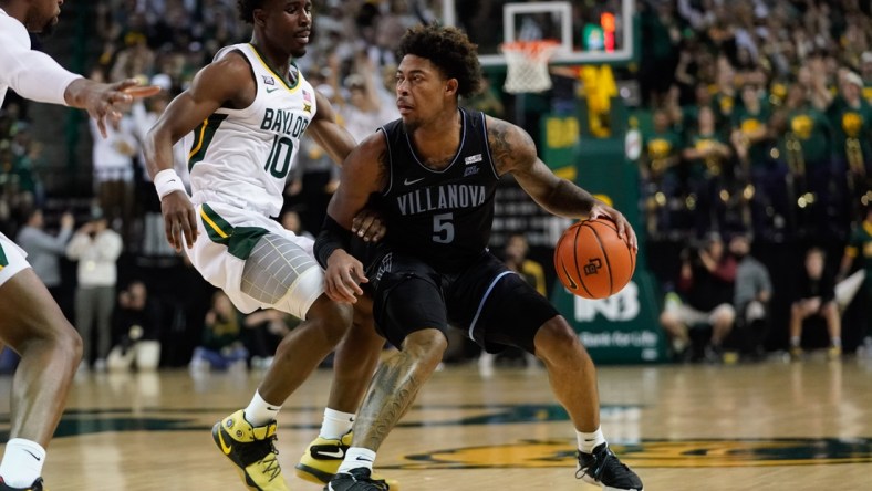 Dec 12, 2021; Waco, Texas, USA;  Villanova Wildcats guard Justin Moore (5) controls the ball against Baylor Bears guard Adam Flagler (10) during the first half at Ferrell Center. Mandatory Credit: Chris Jones-USA TODAY Sports