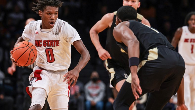 Dec 12, 2021; Brooklyn, New York, USA; North Carolina State Wolfpack guard Terquavion Smith (0) dribbles up court  againstNorth Carolina State Wolfpack guard Thomas Allen (5) during the second half at Barclays Center. Mandatory Credit: Vincent Carchietta-USA TODAY Sports