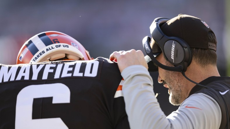 Dec 12, 2021; Cleveland, Ohio, USA; Cleveland Browns head coach Kevin Stefanski talks with quarterback Baker Mayfield (6) during the first quarter against the Baltimore Ravens at FirstEnergy Stadium. Mandatory Credit: Scott Galvin-USA TODAY Sports