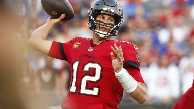 Dec 12, 2021; Tampa, Florida, USA; Tampa Bay Buccaneers quarterback Tom Brady (12) throws the ball against the Buffalo Bills during the first half at Raymond James Stadium. Mandatory Credit: Kim Klement-USA TODAY Sports