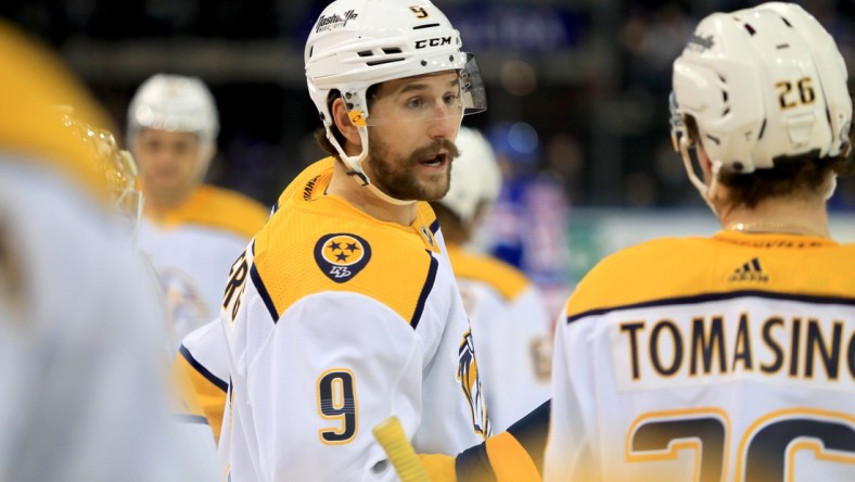 Dec 12, 2021; New York, New York, USA; Nashville Predators left wing Filip Forsberg (9) speaks with center Philip Tomasino (26) during a break against the New York Rangers during the first period at Madison Square Garden. Mandatory Credit: Danny Wild-USA TODAY Sports