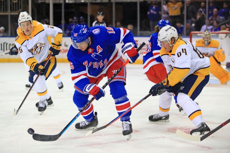 Dec 12, 2021; New York, New York, USA; New York Rangers center Ryan Strome (16) and Nashville Predators center Mikael Granlund (64) fight for the puck during the third period at Madison Square Garden. Mandatory Credit: Danny Wild-USA TODAY Sports