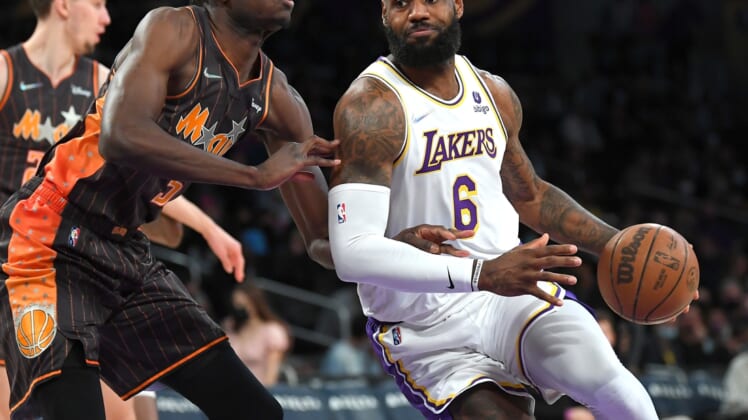 Dec 12, 2021; Los Angeles, California, USA;  Orlando Magic center Mo Bamba (5) guards Los Angeles Lakers forward LeBron James (6) as he drives to the basket in the first quarter of the game at Staples Center. Mandatory Credit: Jayne Kamin-Oncea-USA TODAY Sports