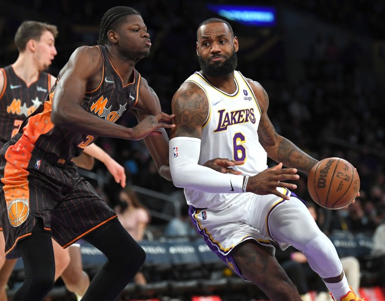 Dec 12, 2021; Los Angeles, California, USA;  Orlando Magic center Mo Bamba (5) guards Los Angeles Lakers forward LeBron James (6) as he drives to the basket in the first quarter of the game at Staples Center. Mandatory Credit: Jayne Kamin-Oncea-USA TODAY Sports