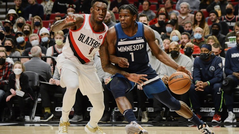 Dec 12, 2021; Portland, Oregon, USA; Minnesota Timberwolves forward Anthony Edwards (1) drives to the basket during the first half against Portland Trail Blazers forward Nassir Little (9) at Moda Center. Mandatory Credit: Troy Wayrynen-USA TODAY Sports