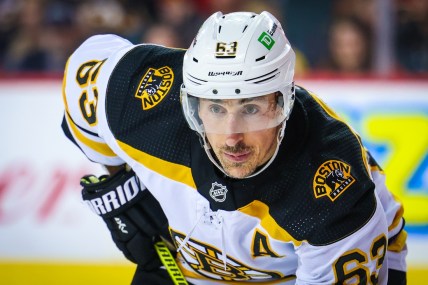 Dec 11, 2021; Calgary, Alberta, CAN; Boston Bruins left wing Brad Marchand (63) during the face off against the Calgary Flames during the second period at Scotiabank Saddledome. Mandatory Credit: Sergei Belski-USA TODAY Sports