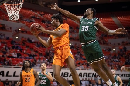 Dec 13, 2021; Stillwater, Oklahoma, USA; Oklahoma State Cowboys forward Matthew-Alexander Moncrieffe (12) shoots the ball while defended by Cleveland State Vikings forward Deante Johnson (35) during the first half at Gallagher-Iba Arena. Mandatory Credit: Rob Ferguson-USA TODAY Sports