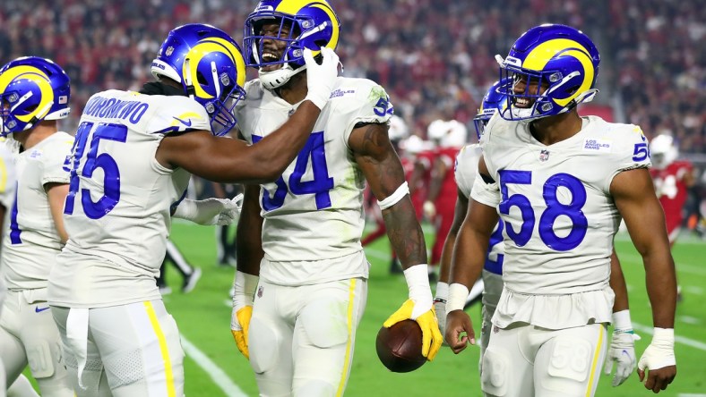 Dec 13, 2021; Glendale, Arizona, USA; Los Angeles Rams outside linebacker Leonard Floyd (54) celebrates with linebacker Obo Okoronkwo (45) and outside linebacker Justin Hollins (58) his interception against the Arizona Cardinals during the second half at State Farm Stadium. Mandatory Credit: Mark J. Rebilas-USA TODAY Sports