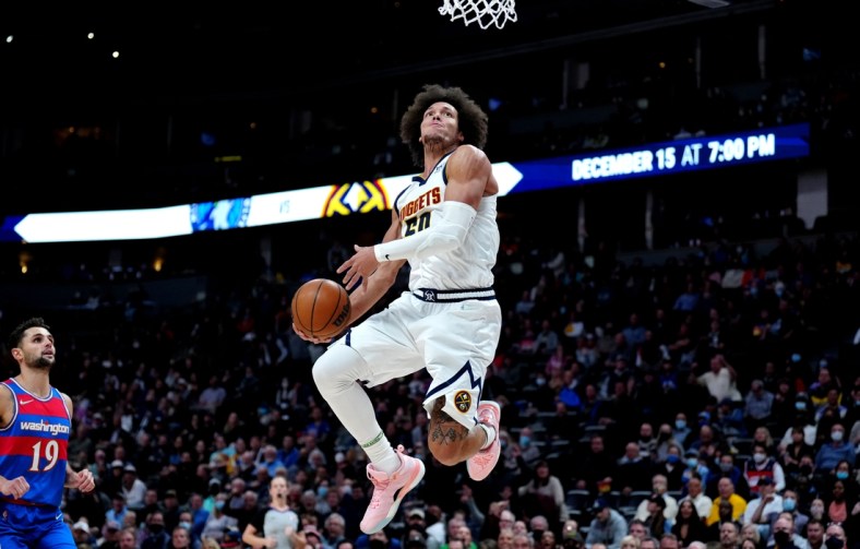 Dec 13, 2021; Denver, Colorado, USA; Denver Nuggets forward Aaron Gordon (50) moves in for a dunk in the second quarter against the Washington Wizards at Ball Arena. Mandatory Credit: Ron Chenoy-USA TODAY Sports