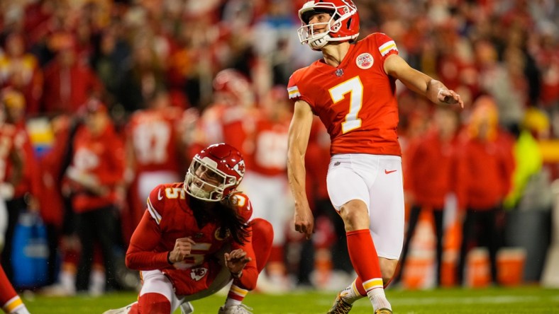 Dec 5, 2021; Kansas City, Missouri, USA; Kansas City Chiefs place kicker Harrison Butker (right) kicks a field goal as punter Tommy Townsend (left) holds during the first half against the Denver Broncos at GEHA Field at Arrowhead Stadium.