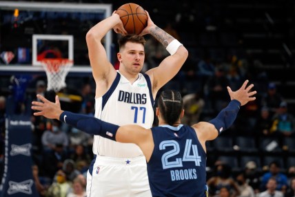 Dec 8, 2021; Memphis, Tennessee, USA; Dallas Mavericks guard Luka Doncic (77) and Memphis Grizzles guard Dillon Brooks (24) during the first half at FedExForum. Mandatory Credit: Petre Thomas-USA TODAY Sports