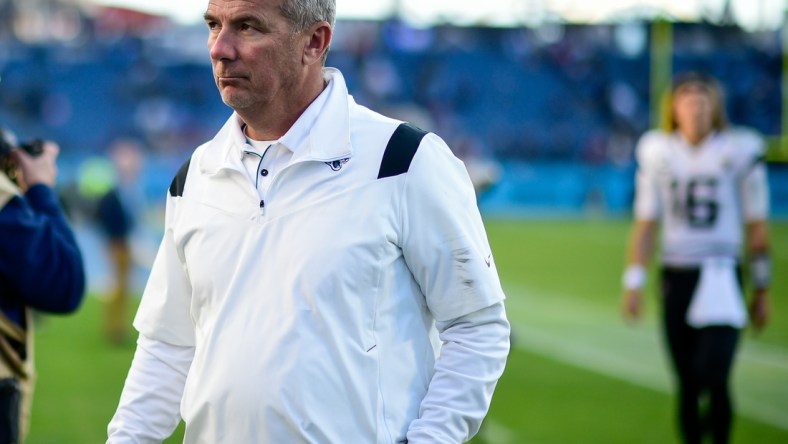 Dec 12, 2021; Nashville, Tennessee, USA;  Jacksonville Jaguars head coach Urban Meyer walks from the field after the game as quarterback Trevor Lawrence (16) follows against the Tennessee Titans at Nissan Stadium. Mandatory Credit: Steve Roberts-USA TODAY Sports