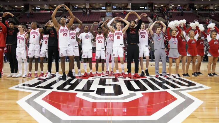 The Ohio State Buckeyes sing "Carmen Ohio" following their 85-74 win over the Towson Tigers in the NCAA men's basketball game at Value City Arena in Columbus on Wednesday, Dec. 8, 2021.Basketball 06