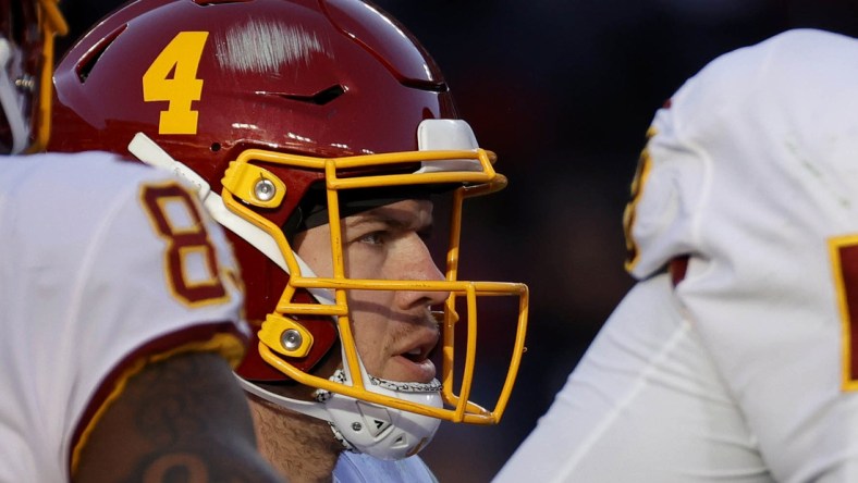 Dec 12, 2021; Landover, Maryland, USA; Washington Football Team quarterback Taylor Heinicke (4) stands in the huddle against the Dallas Cowboys at FedExField. Mandatory Credit: Geoff Burke-USA TODAY Sports