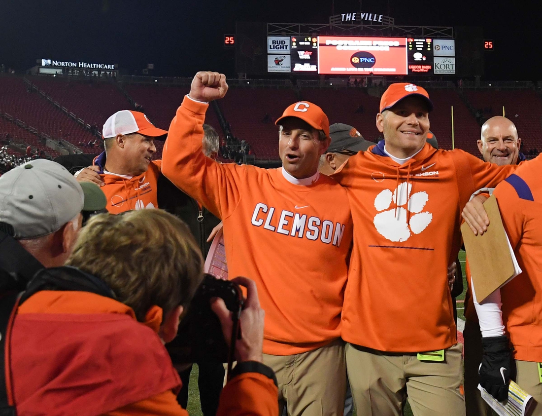 Clemson head coach Dabo Swinney and quarterbacks coach Brandon Streeter celebrate with the team after beating Louisville 30-24 at Cardinal Stadium in Louisville, Kentucky Saturday, November 6, 2021.

Ncaa Football Clemson At Louisville