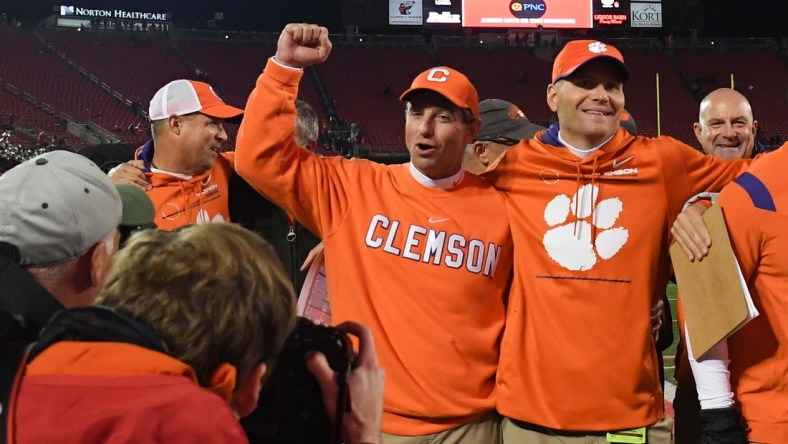 Clemson head coach Dabo Swinney and quarterbacks coach Brandon Streeter celebrate with the team after beating Louisville 30-24 at Cardinal Stadium in Louisville, Kentucky Saturday, November 6, 2021.

Ncaa Football Clemson At Louisville