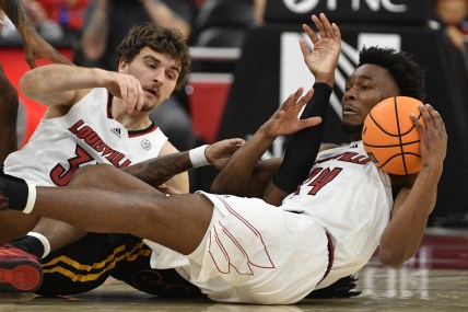 Dec 14, 2021; Louisville, Kentucky, USA;  Louisville Cardinals forward Jae'Lyn Withers (24) scrambles for a loose ball with forward Matt Cross (33) during the first half against the Southeastern Louisiana Lions at KFC Yum! Center. Mandatory Credit: Jamie Rhodes-USA TODAY Sports