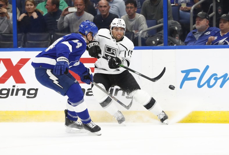 Dec 14, 2021; Tampa, Florida, USA; Los Angeles Kings right wing Alex Iafallo (19) shoots as Tampa Bay Lightning defenseman Jan Rutta (44) defends during the first period at Amalie Arena. Mandatory Credit: Kim Klement-USA TODAY Sports