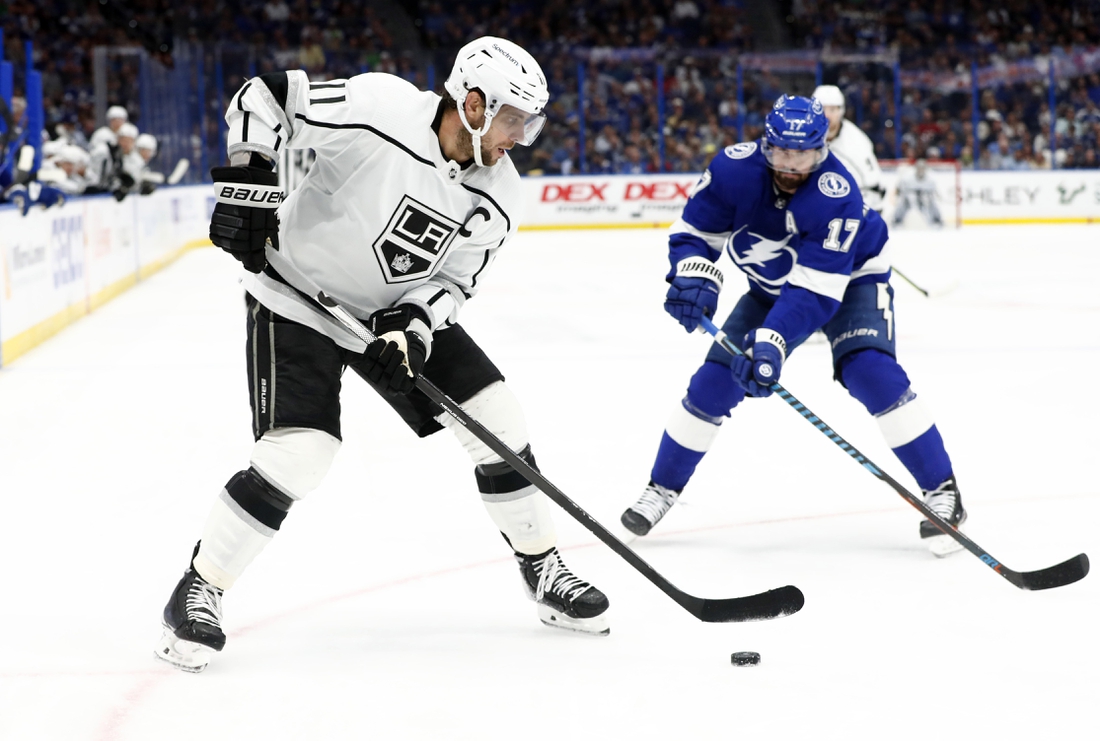 Dec 14, 2021; Tampa, Florida, USA; Los Angeles Kings center Anze Kopitar (11) skates with the puck as Tampa Bay Lightning left wing Alex Killorn (17) defends during the third period at Amalie Arena. Mandatory Credit: Kim Klement-USA TODAY Sports