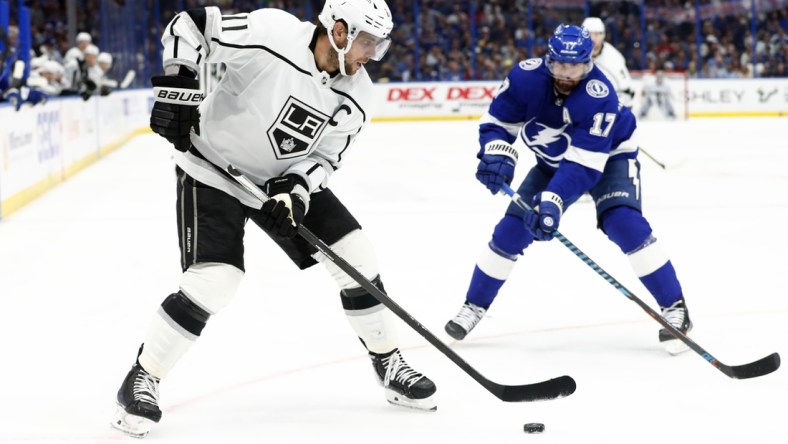 Dec 14, 2021; Tampa, Florida, USA; Los Angeles Kings center Anze Kopitar (11) skates with the puck as Tampa Bay Lightning left wing Alex Killorn (17) defends during the third period at Amalie Arena. Mandatory Credit: Kim Klement-USA TODAY Sports