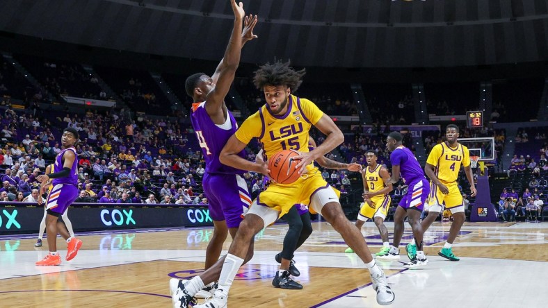 Dec 14, 2021; Baton Rouge, Louisiana, USA;  LSU Tigers center Efton Reid (15) dribbles against Northwestern State Demons center Kendal Coleman (4) during the first half at Pete Maravich Assembly Center. Mandatory Credit: Stephen Lew-USA TODAY Sports