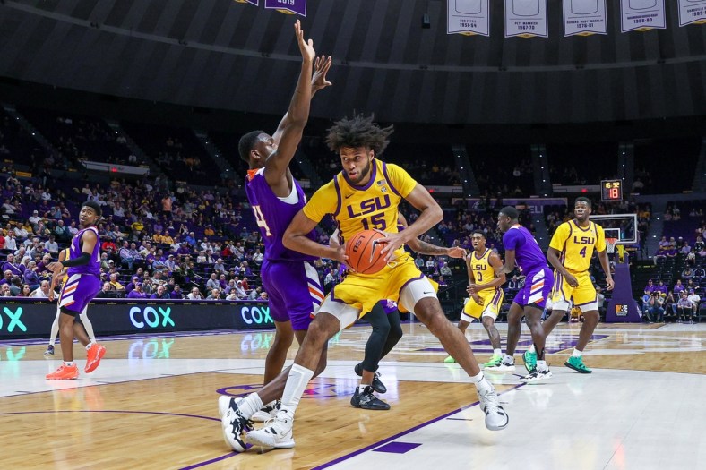 Dec 14, 2021; Baton Rouge, Louisiana, USA;  LSU Tigers center Efton Reid (15) dribbles against Northwestern State Demons center Kendal Coleman (4) during the first half at Pete Maravich Assembly Center. Mandatory Credit: Stephen Lew-USA TODAY Sports