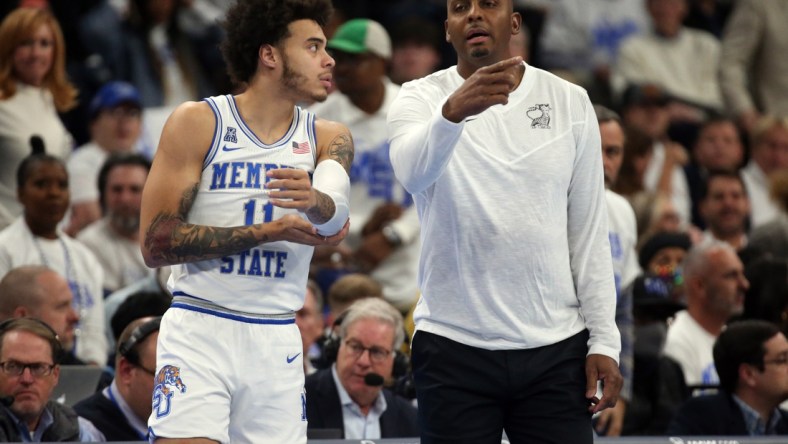 Dec 14, 2021; Memphis, Tennessee, USA; Memphis Tigers head coach Penny Hardaway talks with Memphis Tigers guard Lester Quinones (11) as he checks in during the first half against the Alabama Crimson Tide at FedExForum. Mandatory Credit: Petre Thomas-USA TODAY Sports