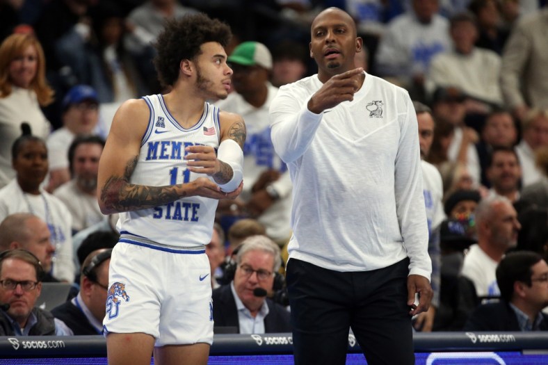 Dec 14, 2021; Memphis, Tennessee, USA; Memphis Tigers head coach Penny Hardaway talks with Memphis Tigers guard Lester Quinones (11) as he checks in during the first half against the Alabama Crimson Tide at FedExForum. Mandatory Credit: Petre Thomas-USA TODAY Sports