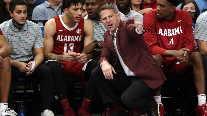 Dec 14, 2021; Memphis, Tennessee, USA; Alabama Crimson Tide head coach Nate Oats talks with Alabama Crimson Tide guard Jahvon Quinerly (13) on the bench during the first half against the Memphis Tigers at FedExForum. Mandatory Credit: Petre Thomas-USA TODAY Sports